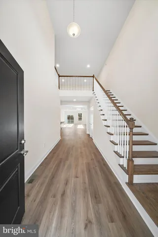 a view of entryway and hall with wooden floor