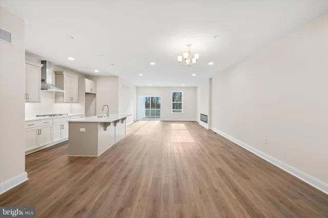a view of kitchen with wooden floor and electronic appliances