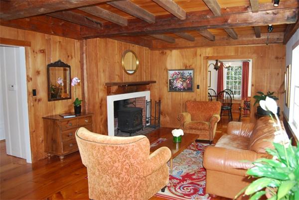 4 Churchill Lane Lexington, MA 02421 - Photo 3 of 30 a living room with furniture a flat screen tv and a fireplace