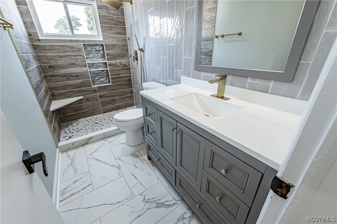 2310 Apollo Road Richmond, VA 23223 - Photo 16 of 22 a bathroom with a sink a toilet and shower