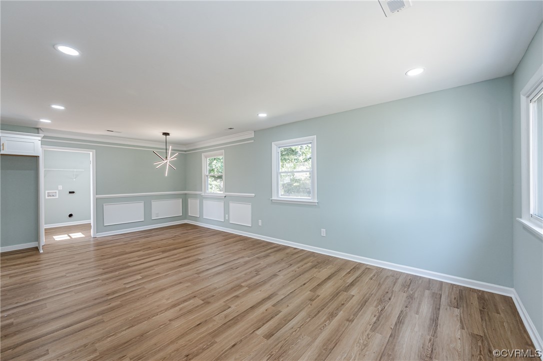 2310 Apollo Road Richmond, VA 23223 - Photo 7 of 22 an empty room with wooden floor and windows
