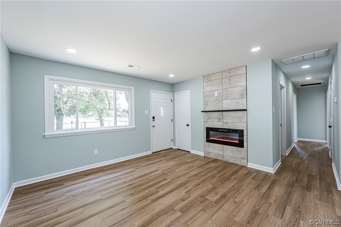 2310 Apollo Road Richmond, VA 23223 - Photo 9 of 22 a view of empty room with a fireplace and wooden floor