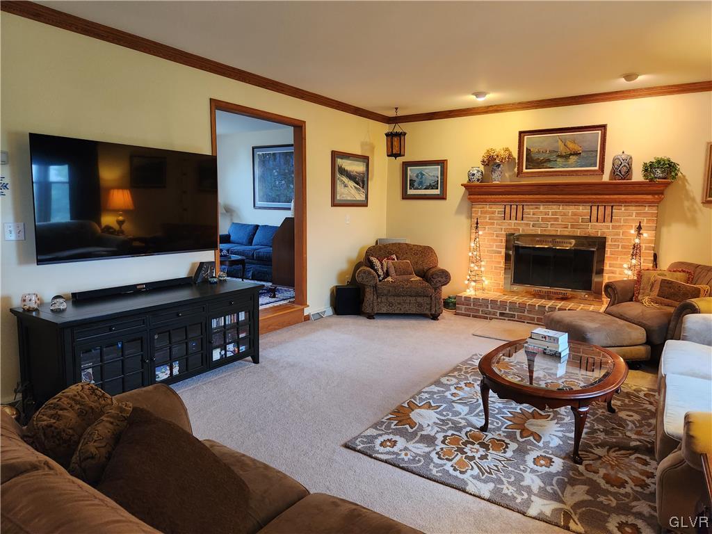 6273 Hower Road Pen Argyl, PA 18072 - Photo 12 of 37 a living room with furniture a flat screen tv and a fireplace