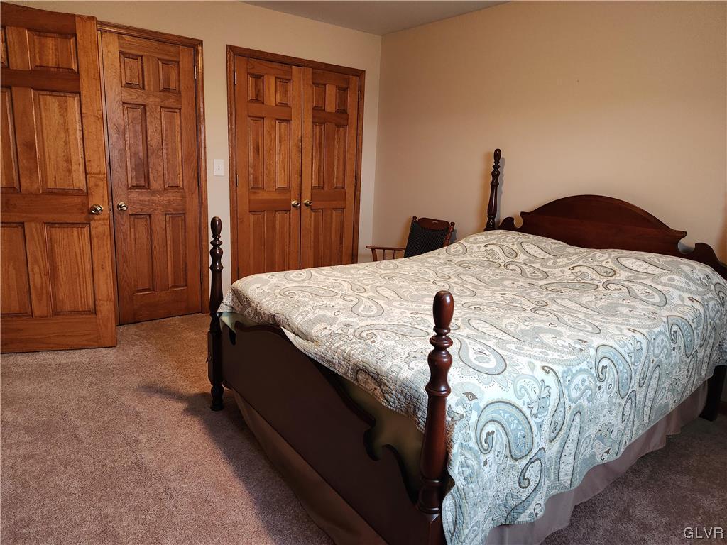 6273 Hower Road Pen Argyl, PA 18072 - Photo 17 of 37 a bed sitting in a bedroom next to a cabinet