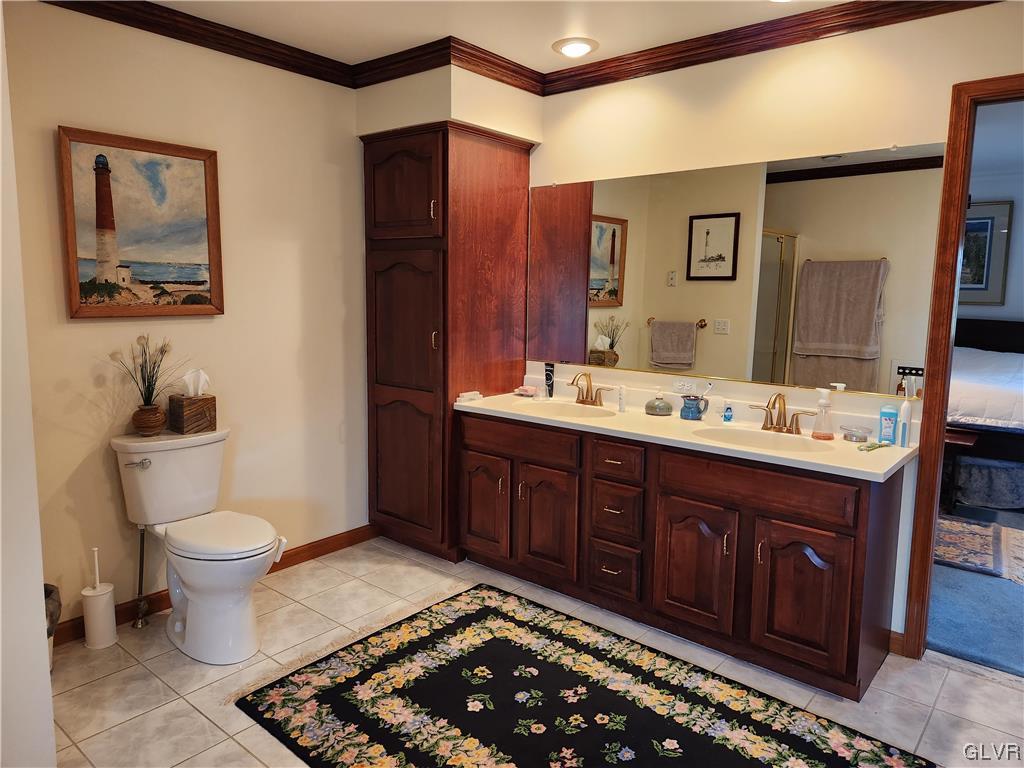 6273 Hower Road Pen Argyl, PA 18072 - Photo 20 of 37 a spacious bathroom with a double vanity sink a toilet and a mirror