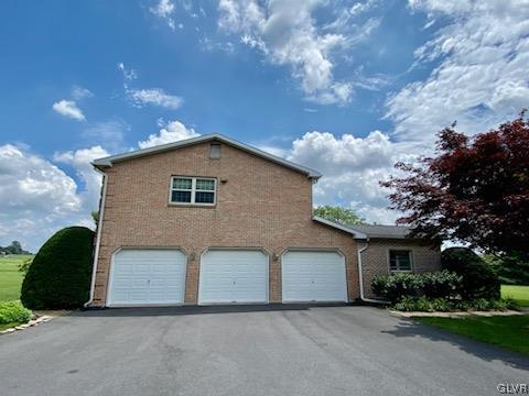 6273 Hower Road Pen Argyl, PA 18072 - Photo 2 of 37 a front view of a house with a yard and garage