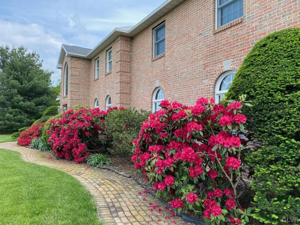 6273 Hower Road Pen Argyl, PA 18072 - Photo 33 of 37 a front view of a house with a yard and fountain