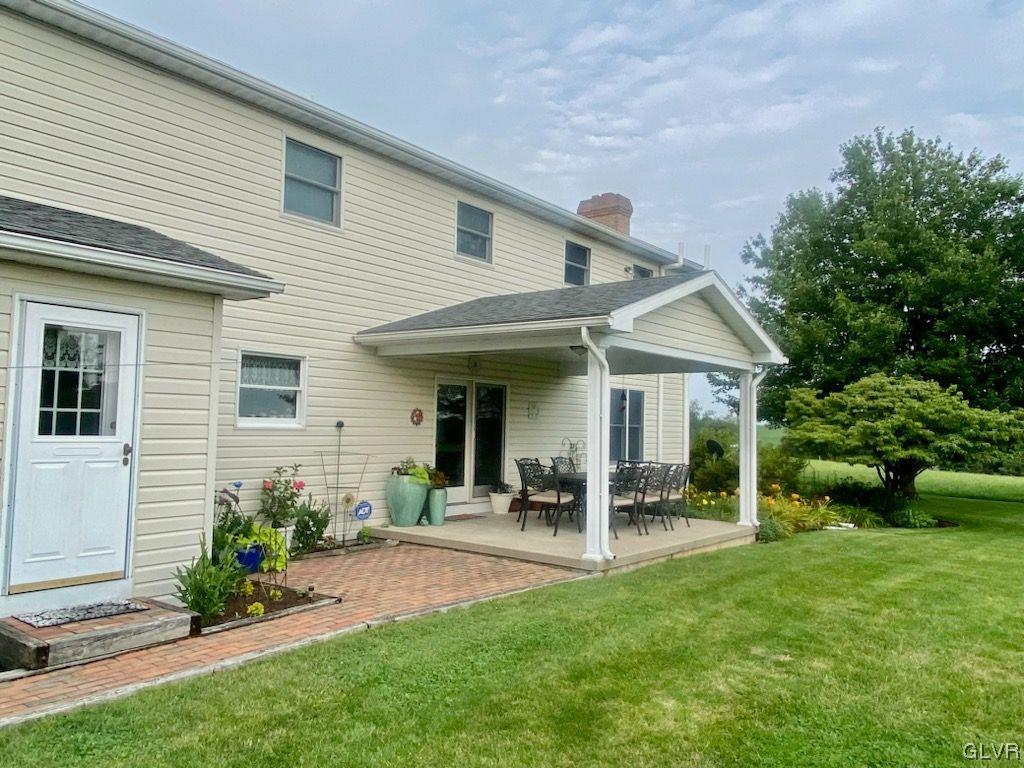 6273 Hower Road Pen Argyl, PA 18072 - Photo 4 of 37 a view of a patio with table and chairs potted plants and large tree