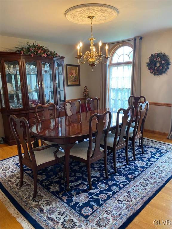 6273 Hower Road Pen Argyl, PA 18072 - Photo 9 of 37 a view of a dining room with furniture a chandelier and wooden floor