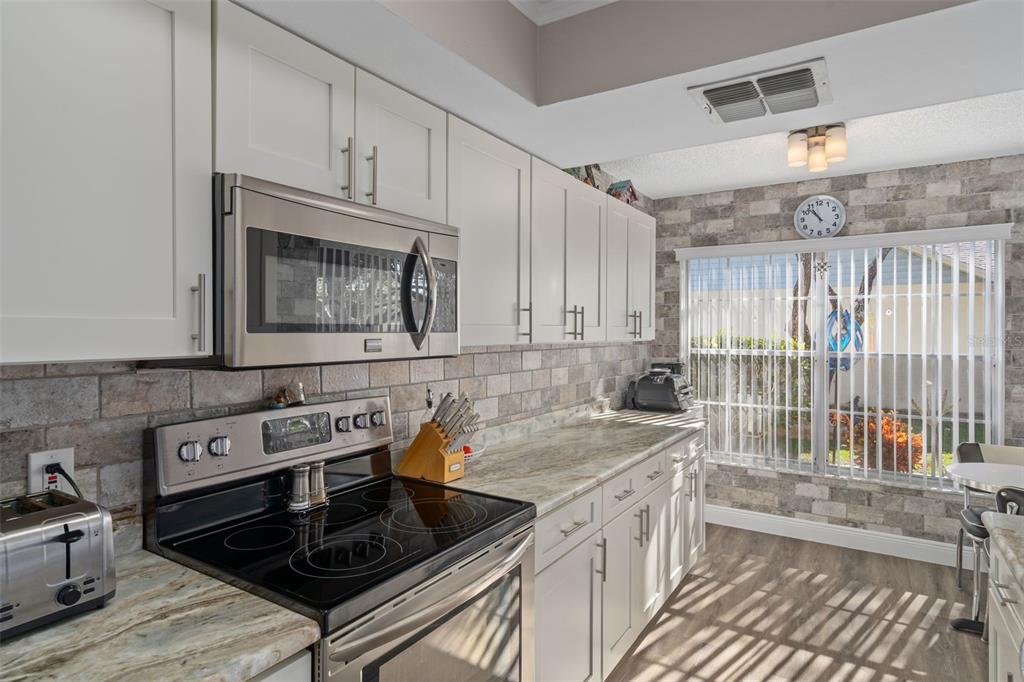 4749 Westbury Court, Unit 19 New Port Richey, FL 34655 - Photo 12 of 46 a kitchen that has a sink and a stove top oven