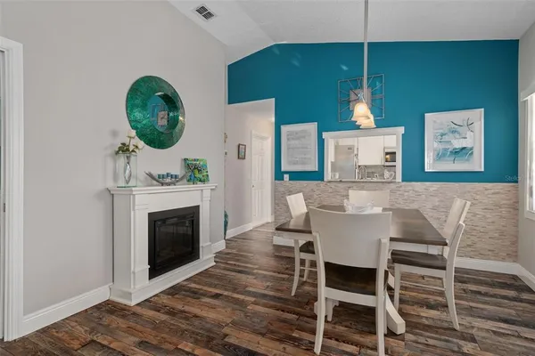 a view of a dining room with furniture and a fireplace