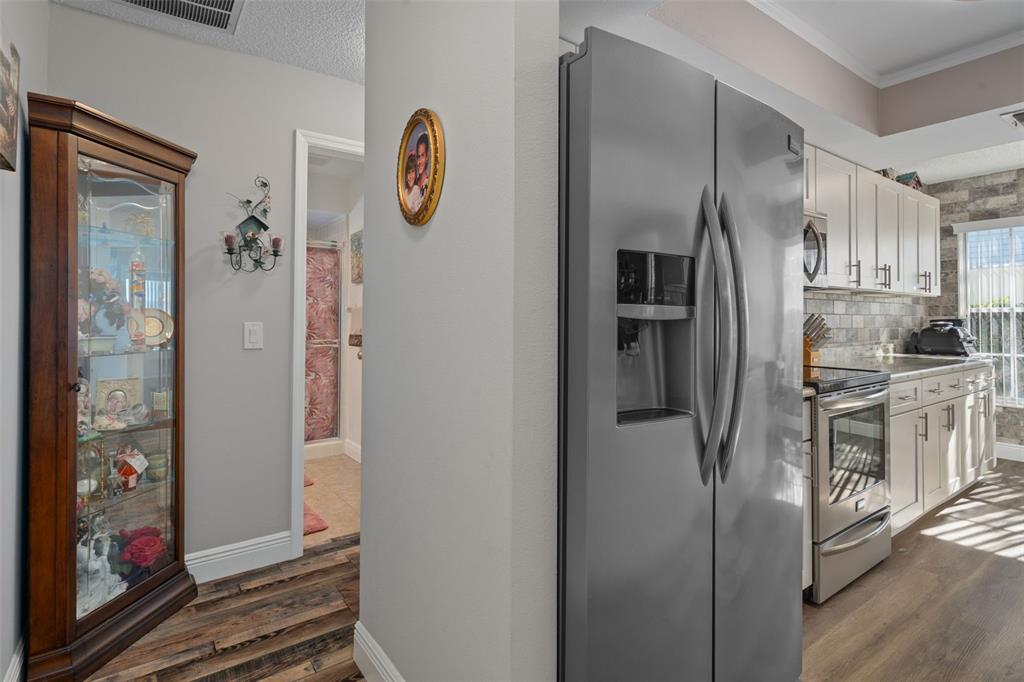4749 Westbury Court, Unit 19 New Port Richey, FL 34655 - Photo 14 of 46 a kitchen with stainless steel appliances granite countertop a refrigerator and a sink