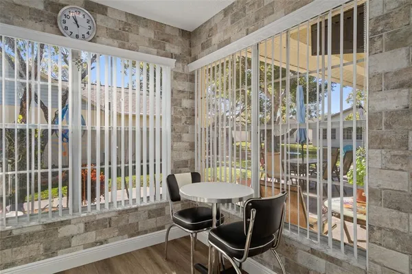 a view of a room with a table and chairs