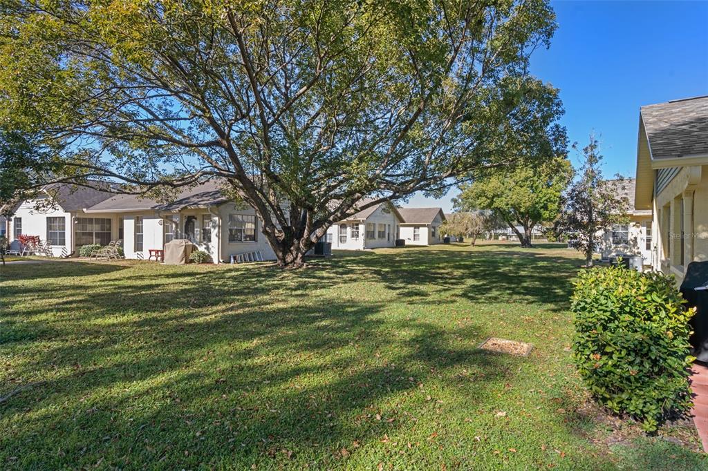 4749 Westbury Court, Unit 19 New Port Richey, FL 34655 - Photo 2 of 46 a front view of a house with a garden