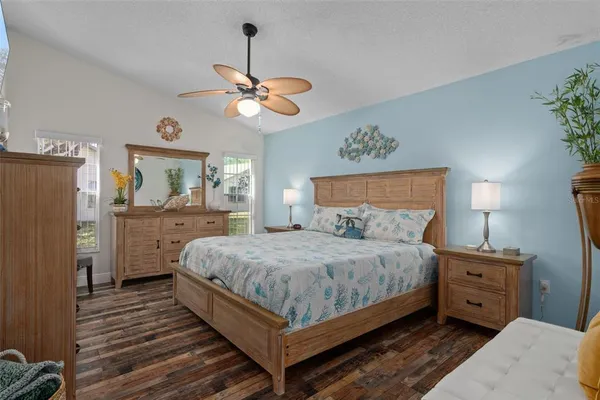 a bedroom with a bed chandelier and a window