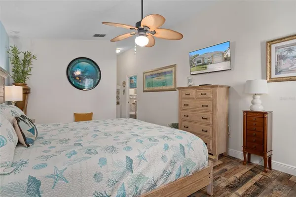 a bedroom with a bed and a chandelier