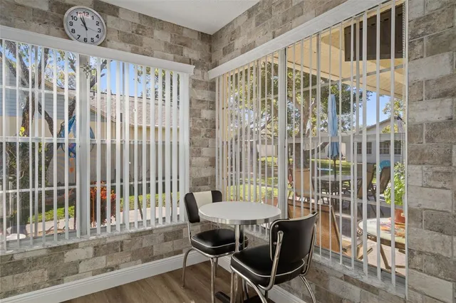 a view of a room with a table and chairs