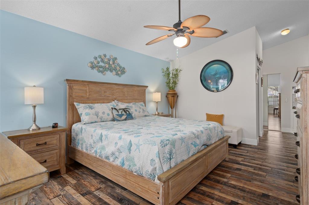 4749 Westbury Court, Unit 19 New Port Richey, FL 34655 - Photo 25 of 46 a bedroom with a bed and a chandelier