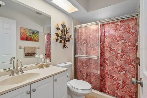 a bathroom with a sink mirror vanity and toilet