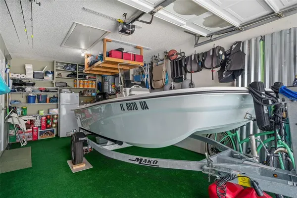 a utility room with fridge dryer and washer