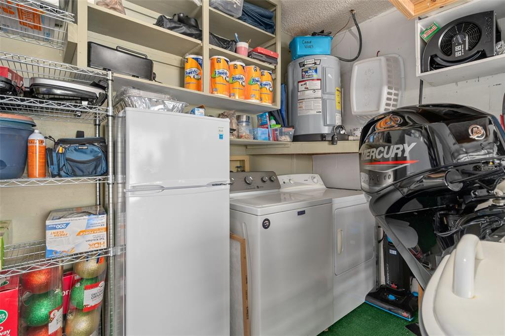 4749 Westbury Court, Unit 19 New Port Richey, FL 34655 - Photo 37 of 46 a utility room with fridge dryer and washer