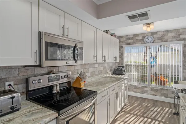a kitchen that has a sink and a stove top oven