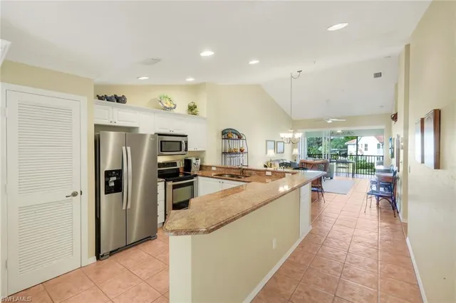 a large kitchen with stainless steel appliances lots of counter top space