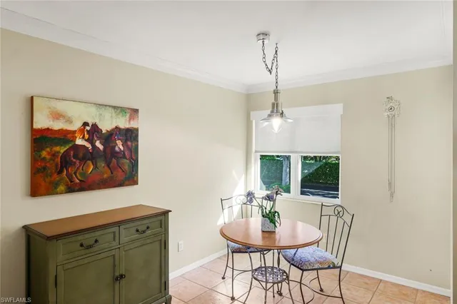 a view of a dining room with furniture a chandelier and wooden floor