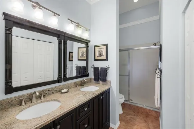 a bathroom with a granite countertop sink mirror and double