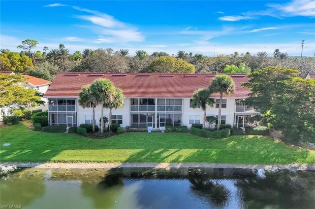 an aerial view of residential building and lake