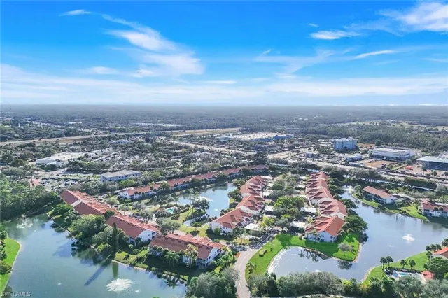an aerial view of residential houses with outdoor space and lake view