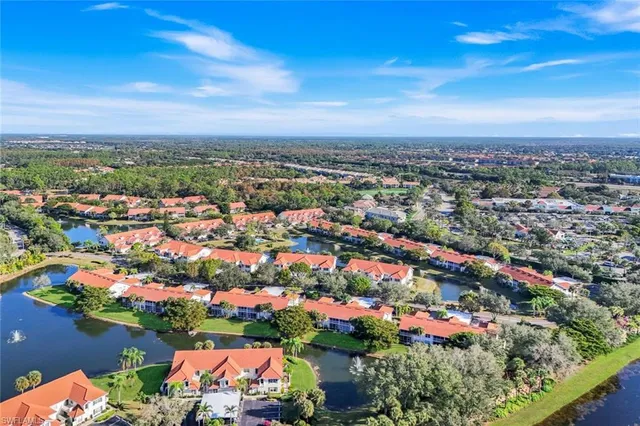 an aerial view of a house with a lake view