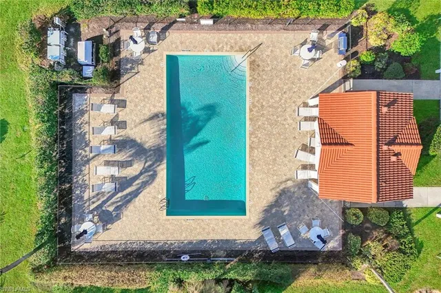 an aerial view of house with yard and mountain view in back