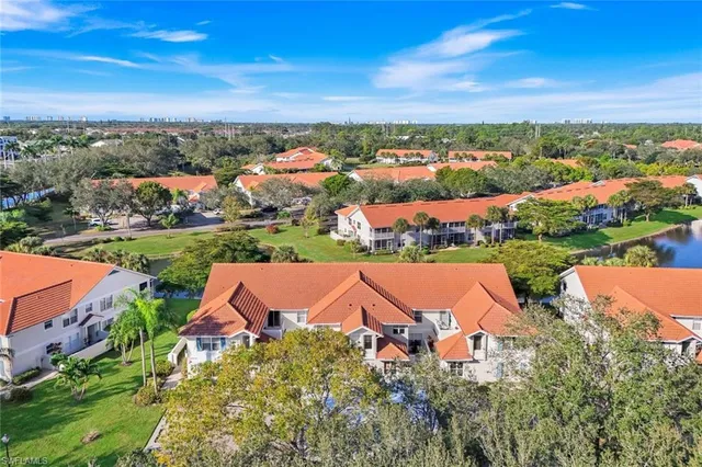 an aerial view of a house with a yard and lake view
