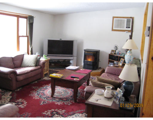 64 Wheeler Road Princeton, MA 01541 - Photo 7 of 13 a living room with furniture a flat screen tv and a fireplace