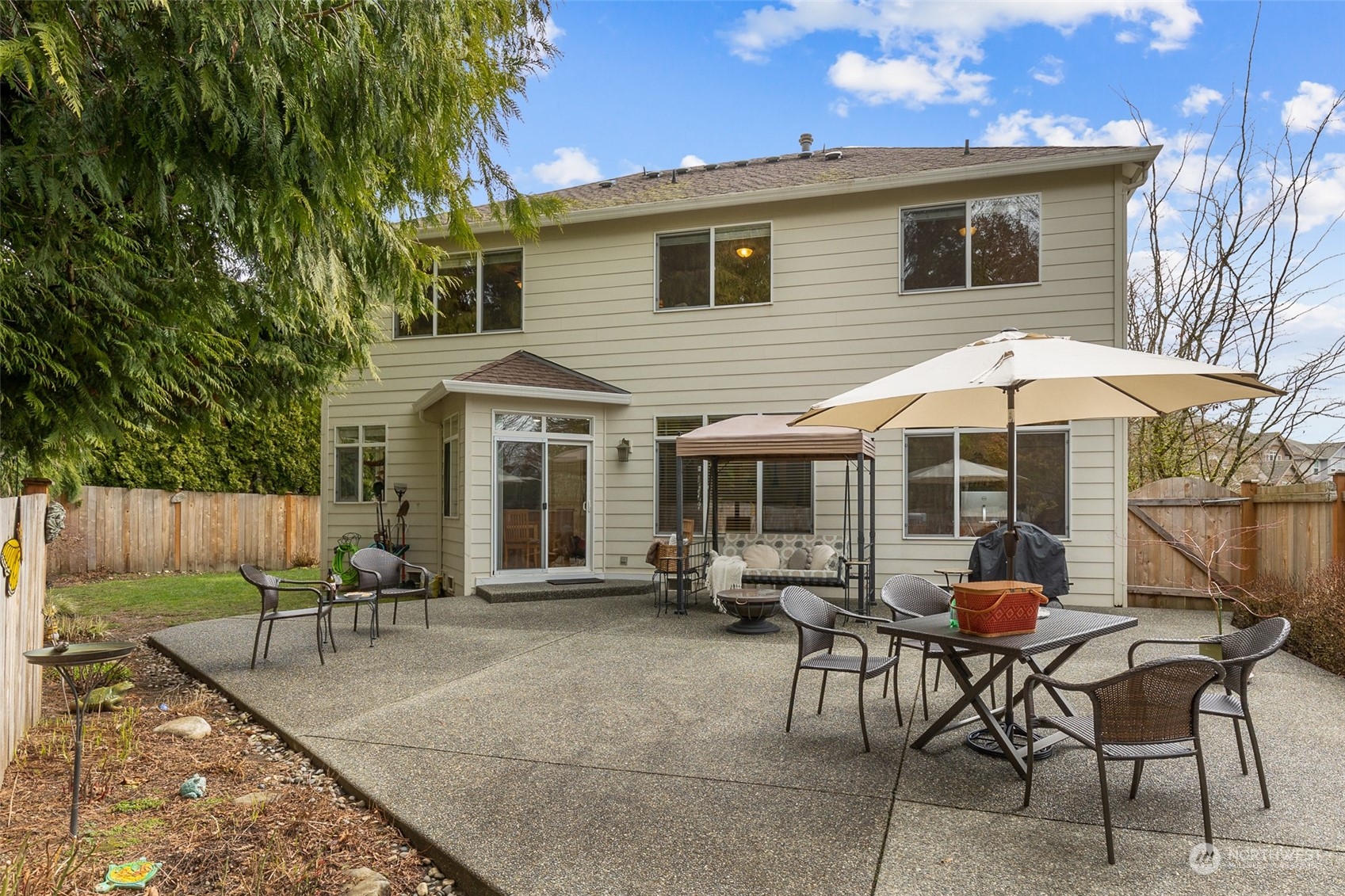 17110 16th Avenue Southeast Bothell, WA 98012 - Photo 5 of 28 a view of a patio with table and chairs under an umbrella with wooden fence