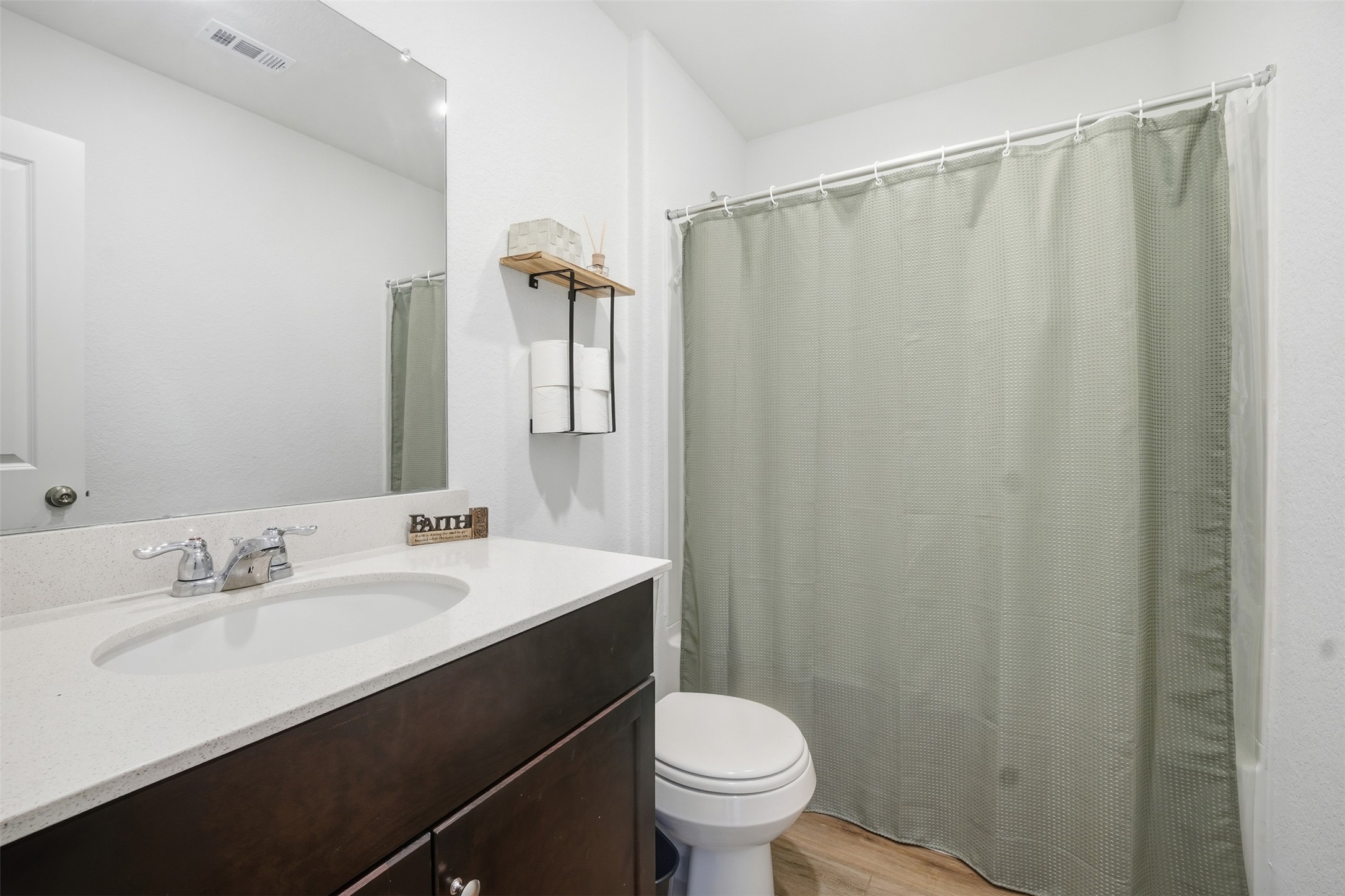 625 Marty Allen Loop Jarrell, TX 76537 - Photo 17 of 25 a bathroom with a sink a toilet a mirror and shower