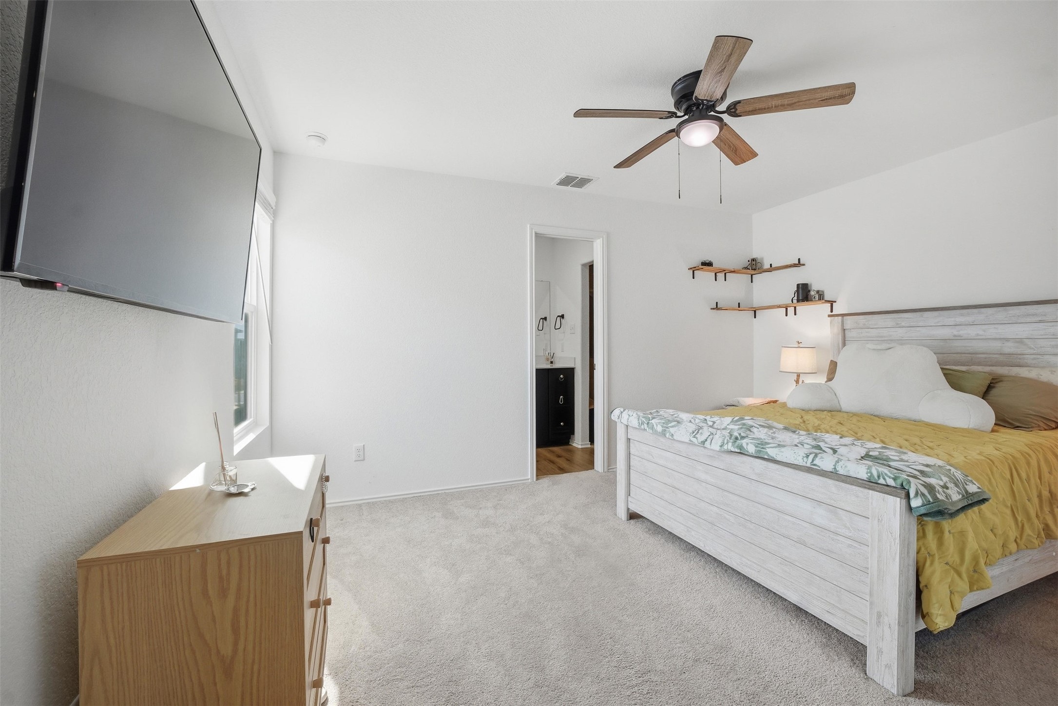 625 Marty Allen Loop Jarrell, TX 76537 - Photo 18 of 25 a bedroom with a bed and a chandelier