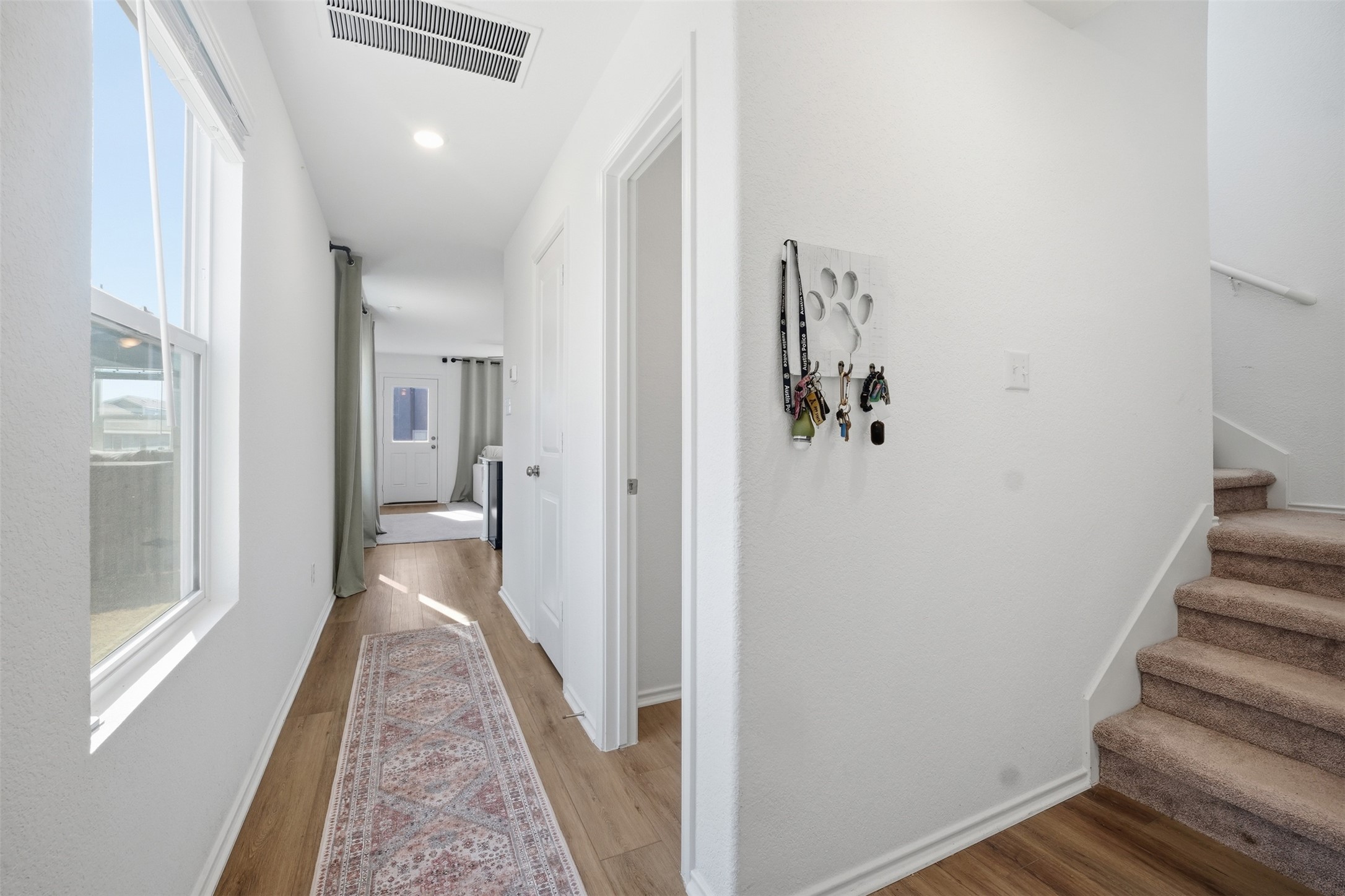 625 Marty Allen Loop Jarrell, TX 76537 - Photo 5 of 25 a view of a hallway with wooden floor and staircase
