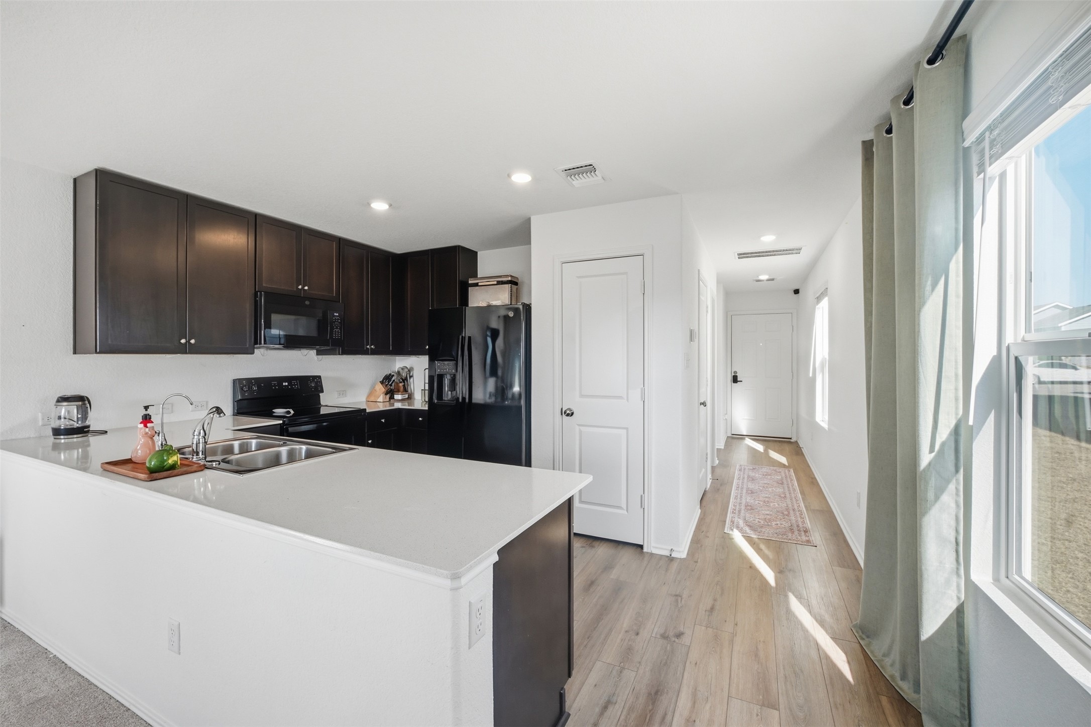 625 Marty Allen Loop Jarrell, TX 76537 - Photo 9 of 25 a kitchen that has a lot of cabinets a sink and appliances in it
