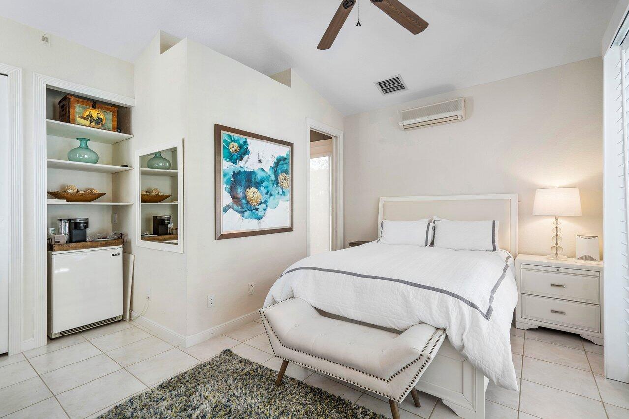 6379 Avalon Pointe Court Boca Raton, FL 33496 - Photo 17 of 37 a bedroom with a bed and a painting on the wall