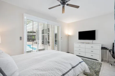 a bedroom with a bed and a painting on the wall