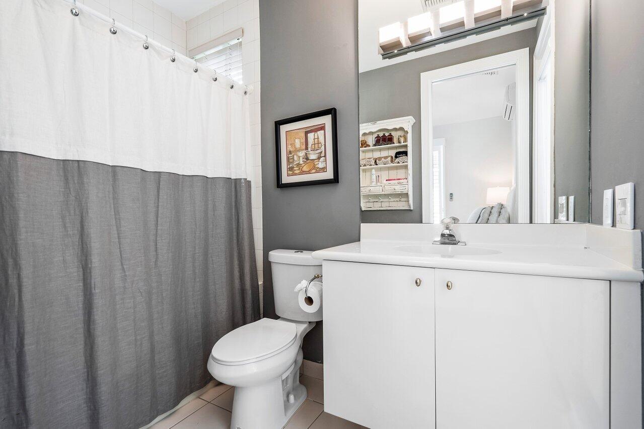 6379 Avalon Pointe Court Boca Raton, FL 33496 - Photo 19 of 37 a bathroom with a sink a toilet and a mirror