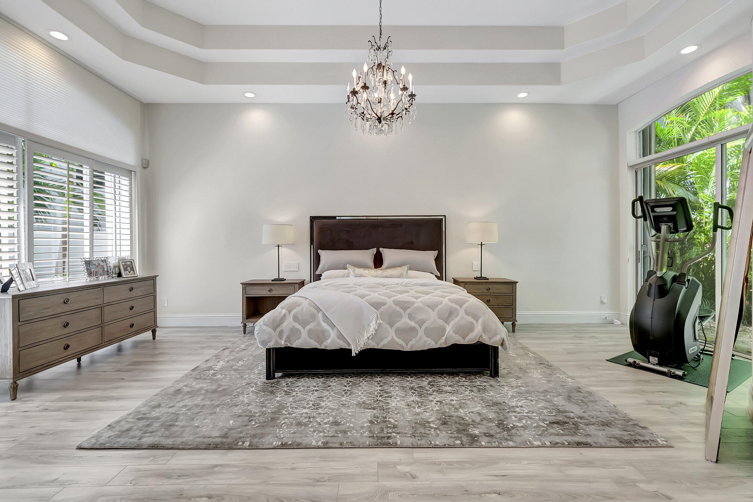 6379 Avalon Pointe Court Boca Raton, FL 33496 - Photo 6 of 37 a bedroom with a bed and a chandelier