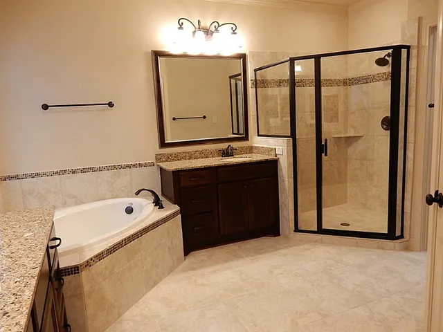 a bathroom with a tub sink and mirror