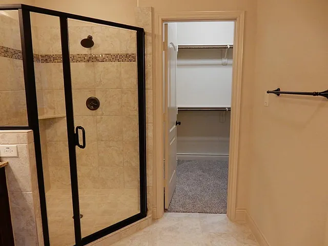 a bathroom with a glass shower door