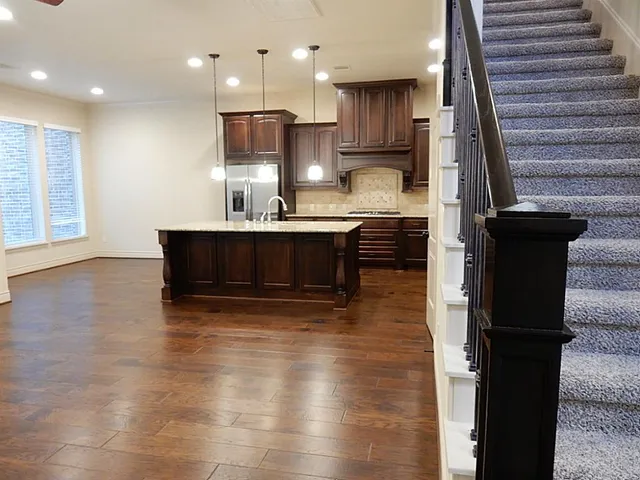 a kitchen with kitchen island sink stove and refrigerator