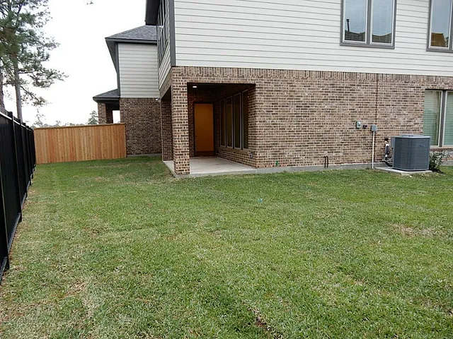 a view of a backyard with a garden and entertaining space