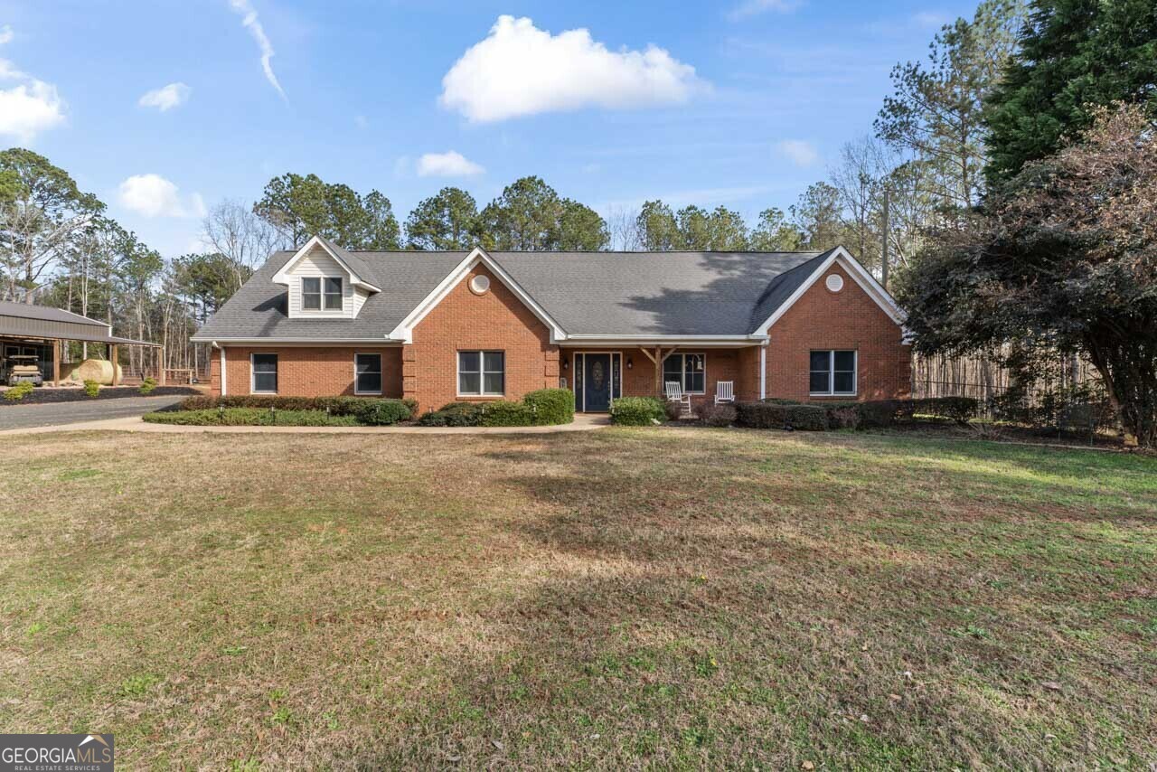 a front view of house with yard and green space