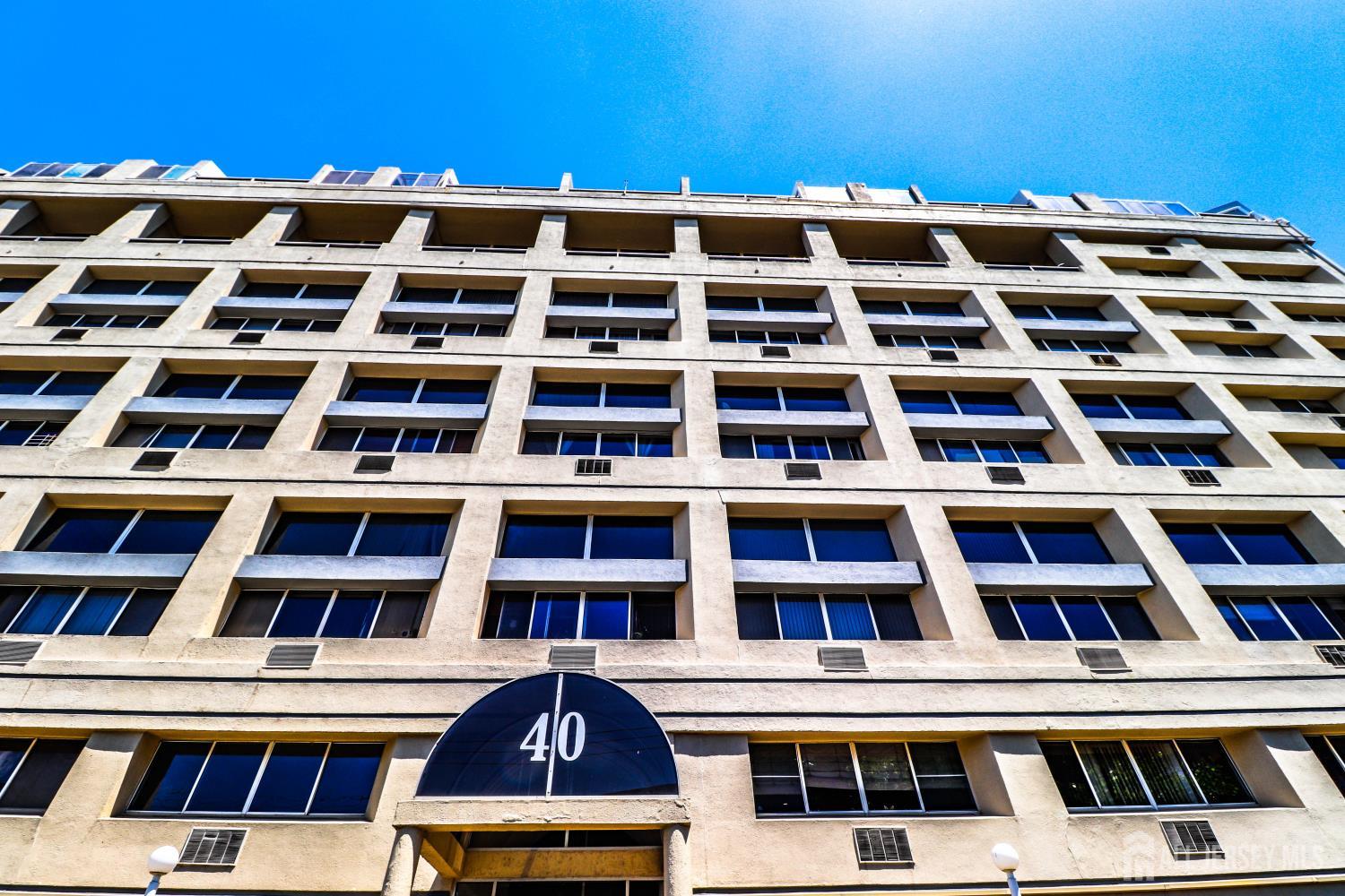 40 Fayette Street, Unit 57 Perth Amboy, NJ 08861 - Photo 7 of 33 a front view of a building with a lot of windows